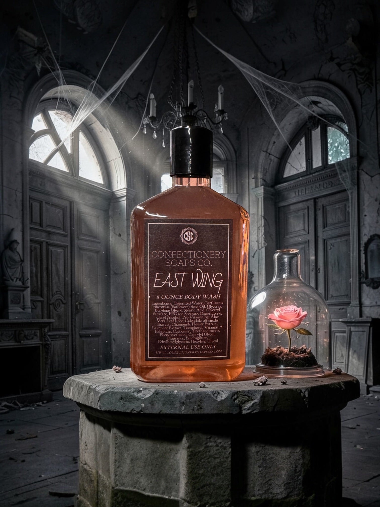 Bottle of Constance's Soaps Co. East Wing soap in a dark, eerie room with cobwebs.