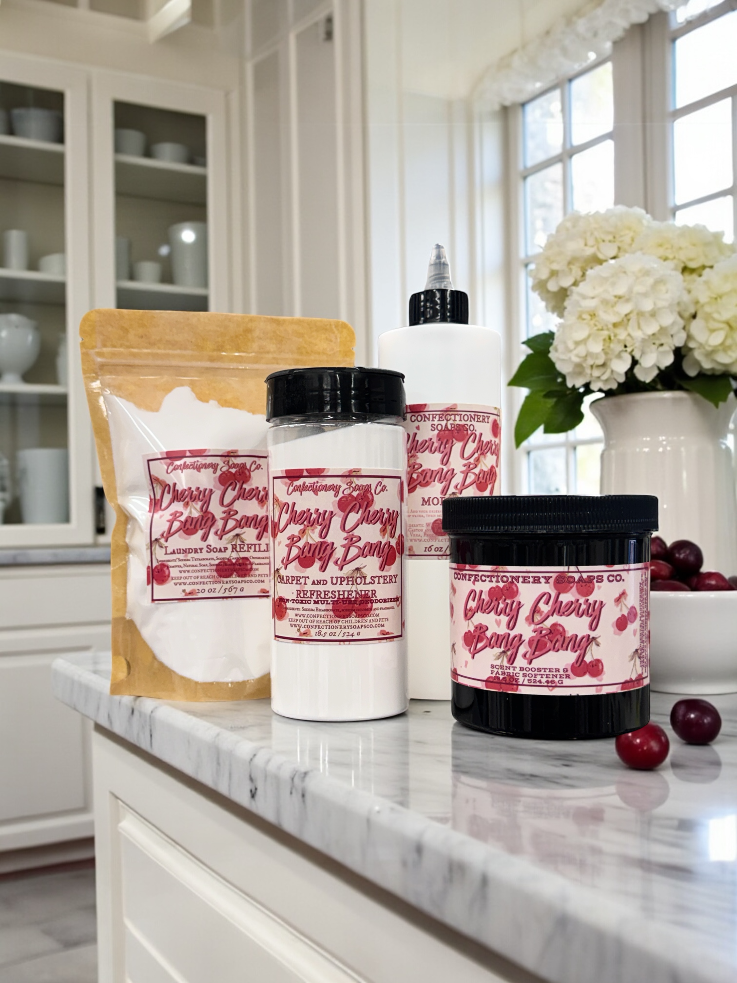 Cherry Bomb products on a kitchen counter with cherry and flower decor.