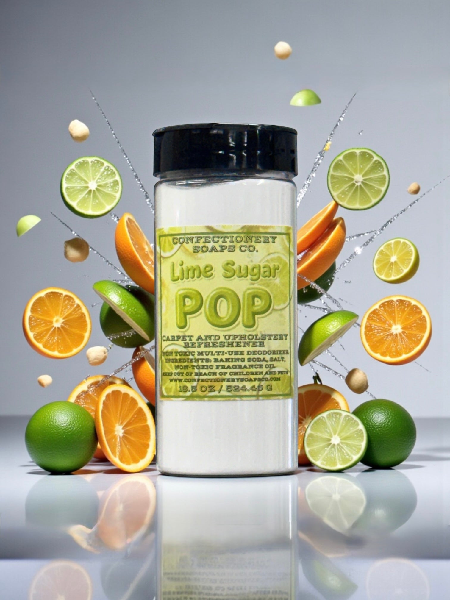 Jar of Lime Sugar Pop with lime and orange slices on a reflective surface