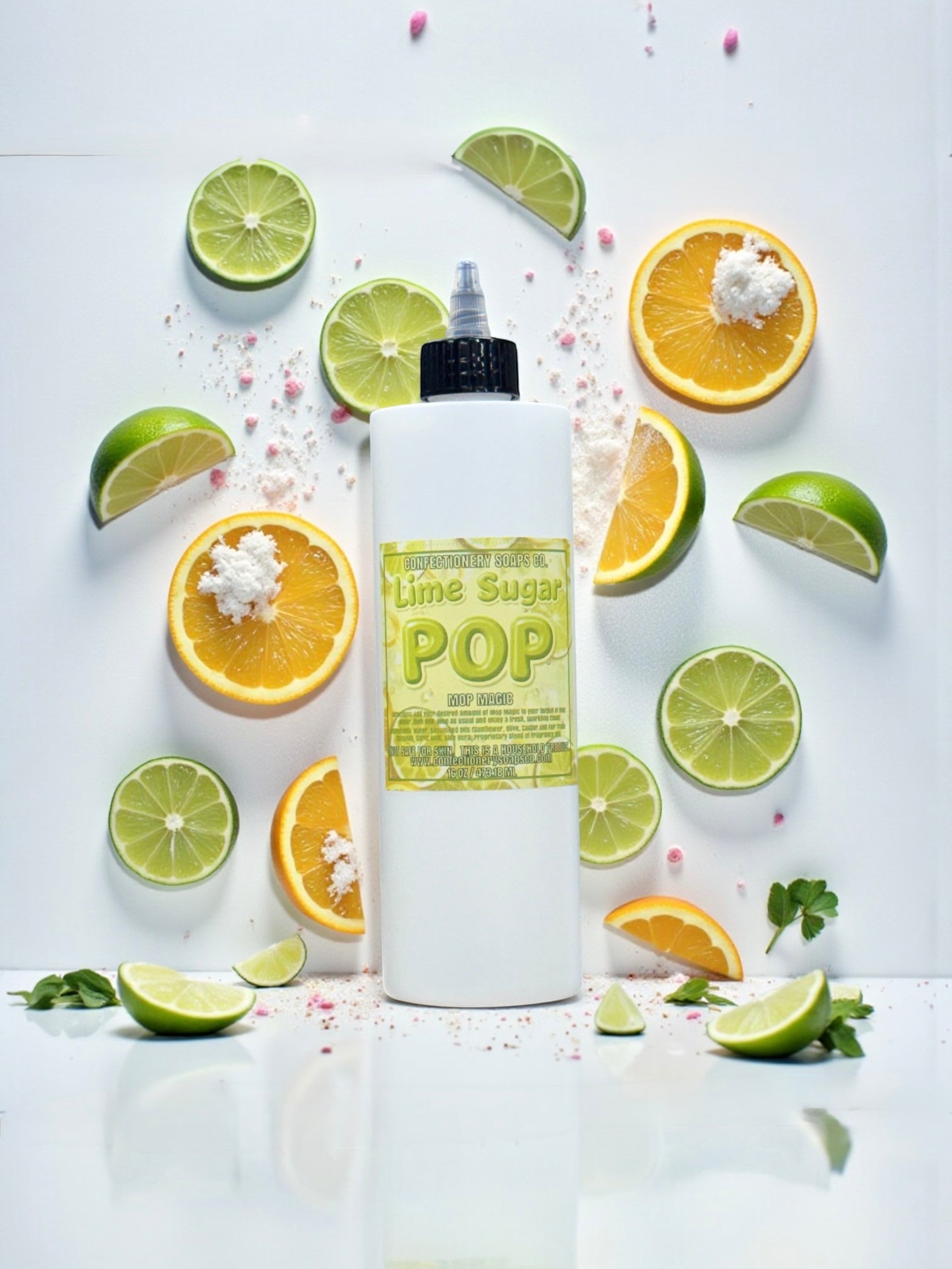White bottle labeled 'Lime Sugar Pop' surrounded by lime and orange slices on a white background